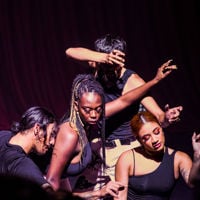 Dancers intertwine their bodies on stage during a dance performance 