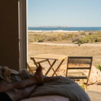 You can see what the view from the bed at Pod[e] Mulla Mulla looks like, with blue ocean in the distance