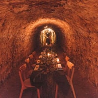 Underground tunnels of Maxwell Wines, with a long table set with candlelight 