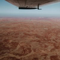 Bird's-eye view of the pinkish Kati Thanda-Lake Eye from the airplane in the outback of South Australia