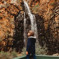 Child standing watching the waterfall cascade at Morialta Conservation Park
