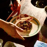Africola's Duncan Welgemoed with a tea towel and giant fish slung over his shoulder.
