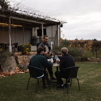 Two friends enjoying a wine and produce platter at Banrock Station overlooking the Riverland